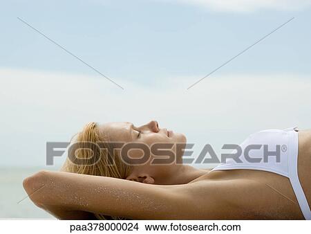 Woman sunbathing, profile View Large Photo Image Picture - Woman sunbathing, profile. Fotosearch