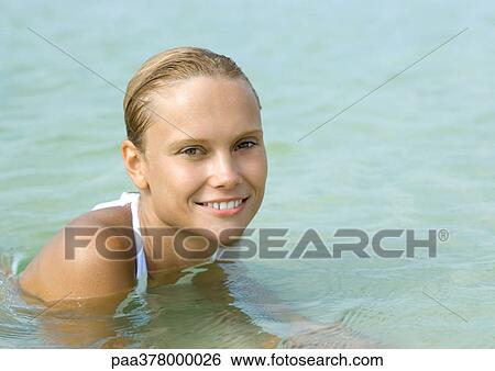 Woman wading in sea, smiling View Large Photo Image Stock Photograph - Woman wading in sea, smiling. Fotosearch