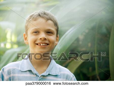 Boy standing in mist, smiling View Large Photo Image Stock Photograph - Boy standing in mist, smiling. Fotosearch