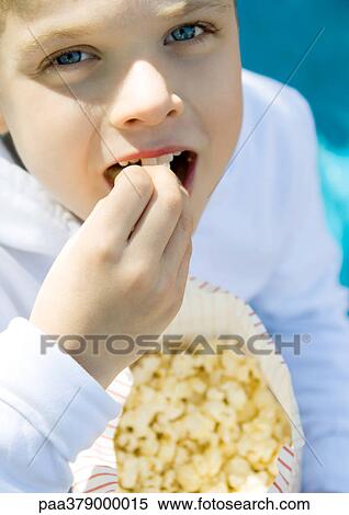 Child eating popcorn View Large Photo Image Stock Photography - Child eating popcorn. Fotosearch