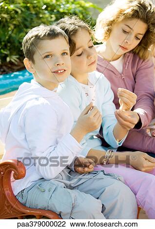 Children sitting on bench outdoors View Large Photo Image Stock Image - Children sitting on bench outdoors. Fotosearch