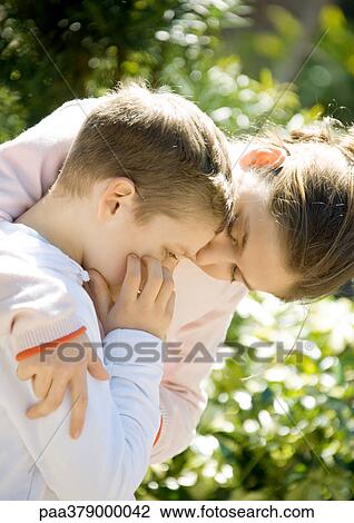 Stock Image - Girl comforting little brother. Fotosearch