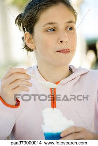 Girl eating sweet desset View Large Photo Image Picture - Girl eating sweet desset. Fotosearch