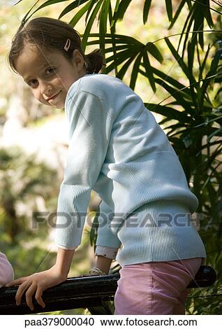 Girl leaning against railing View Large Photo Image Stock Image - Girl leaning against railing. Fotosearch
