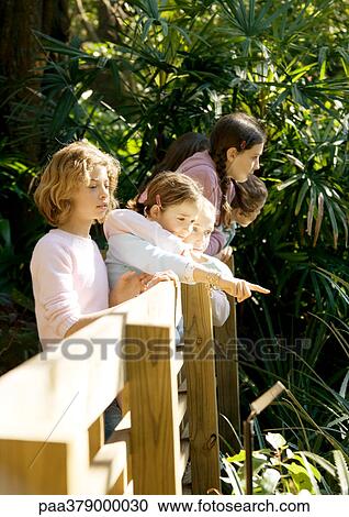 Group of children looking over railing View Large Photo Image Stock Image - Group of children looking over railing. Fotosearch