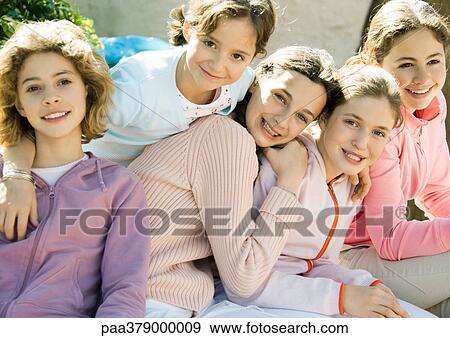 Stock Photo - Group of preteen girls, smiling. Fotosearch