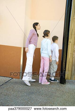 Line of children peeking around wall View Large Photo Image Stock Photo - Line of children peeking around wall. Fotosearch