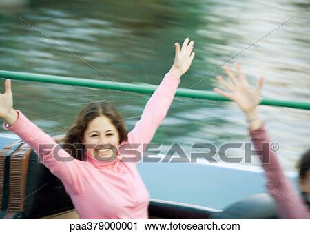 Teen girl on amusement park ride, arms in the air View Large Photo Image Stock Image - Teen girl on amusement park ride, arms in the air. Fotosearch