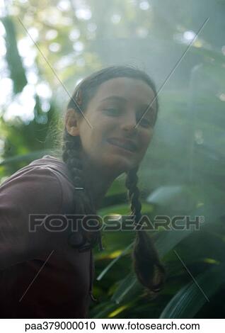 Teen girl smiling in mist View Large Photo Image Stock Image - Teen girl smiling in mist. Fotosearch