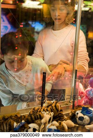 Two girls playing toy grabbing game View Large Photo Image Stock Photo - Two girls playing toy grabbing game. Fotosearch