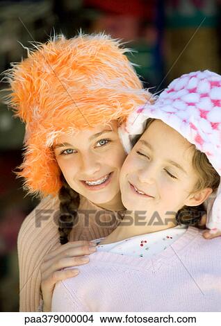 Picture - Two girls wearing funny hats, portrait. Fotosearch
