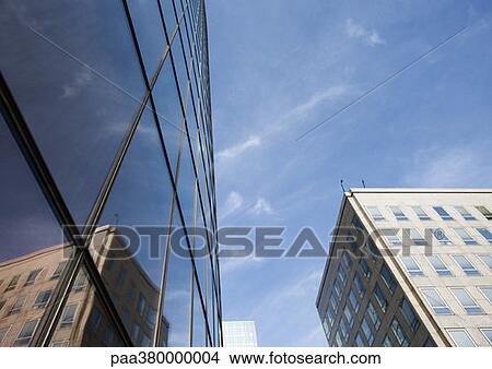 Building reflected on skycraper windows, low angle view View Large Photo Image Picture - Building reflected on skycraper windows, low angle view. Fotosearch