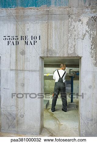 Factory worker, seen through doorway View Large Photo Image Stock Image - Factory worker, seen through doorway. Fotosearch