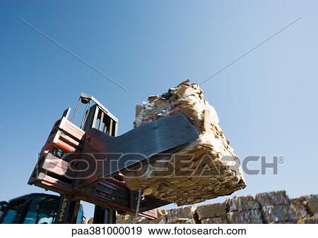 Stock Photo - Forklift transporting bales of paper. Fotosearch