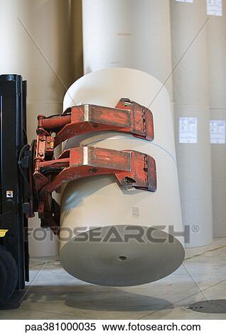 Stock Photography - Forklift transporting roll of paper in warehouse. Fotosearch