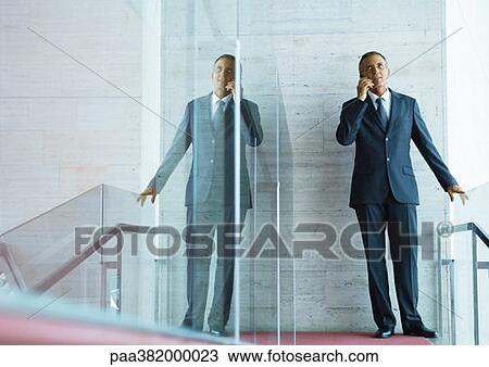 Businessman using cell phone View Large Photo Image Stock Image - Businessman using cell phone. Fotosearch