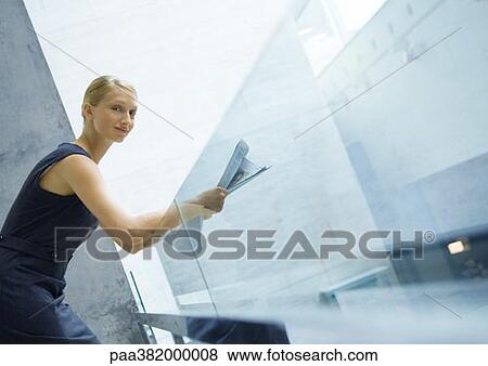 Stock Photo - Businesswoman reading newspaper. Fotosearch