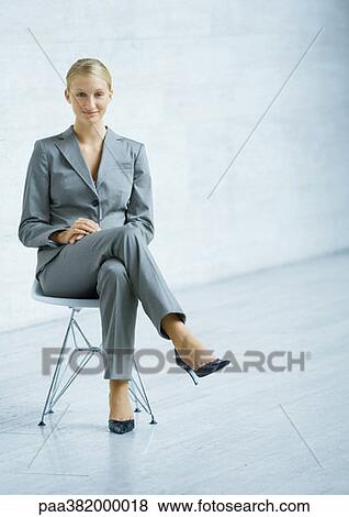 Businesswoman sitting in chair, full length View Large Photo Image Stock Photo - Businesswoman sitting in chair, full length. Fotosearch