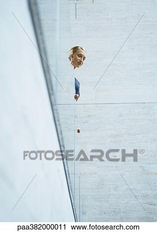 Woman looking over edge of balcony View Large Photo Image Stock Image - Woman looking over edge of balcony. Fotosearch