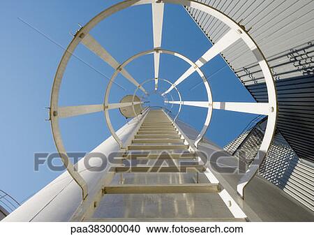 Stock Image - Safety ladder in industrial area, view from directly underneath. Fotosearch
