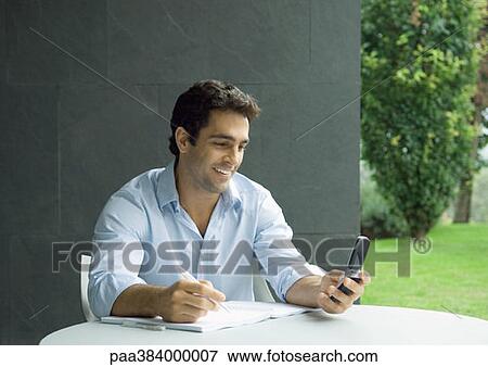 Casually dressed young executive working outdoors View Large Photo Image Stock Photo - Casually dressed young executive working outdoors. Fotosearch