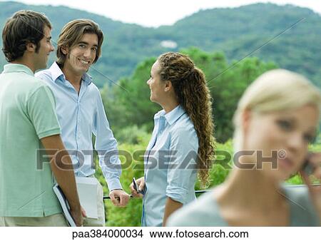Casually dressed young executives working outdoors View Large Photo Image Picture - Casually dressed young executives working outdoors. Fotosearch