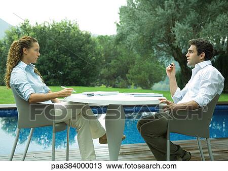 Casually dressed young executives working near edge of pool View Large Photo Image Stock Image - Casually dressed young executives working near edge of pool. Fotosearch