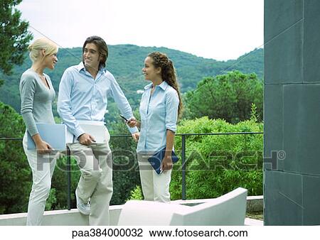 Casually dressed young executives working outdoors View Large Photo Image Stock Image - Casually dressed young executives working outdoors. Fotosearch