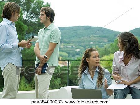 Casually dressed young executives working outdoors View Large Photo Image Stock Image - Casually dressed young executives working outdoors. Fotosearch