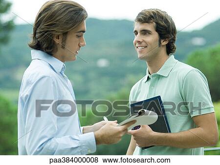 Casually dressed young executives working outdoors View Large Photo Image Stock Photo - Casually dressed young executives working outdoors. Fotosearch