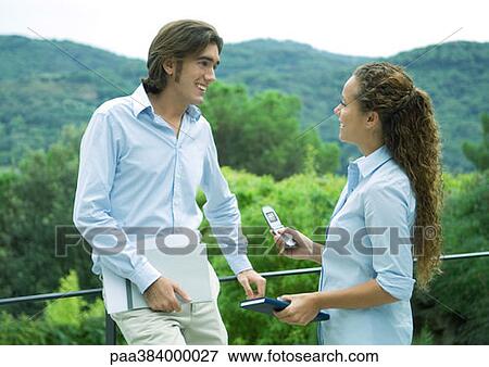 Casually dressed young executives standing outdoors, talking View Large Photo Image Stock Photo - Casually dressed young executives standing outdoors, talking. Fotosearch