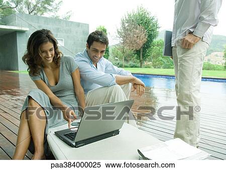 Casually dressed young executives working near edge of pool View Large Photo Image Stock Photography - Casually dressed young executives working near edge of pool. Fotosearch