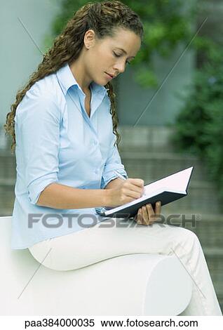 Woman writing outdoors View Large Photo Image Stock Photography - Woman writing outdoors. Fotosearch