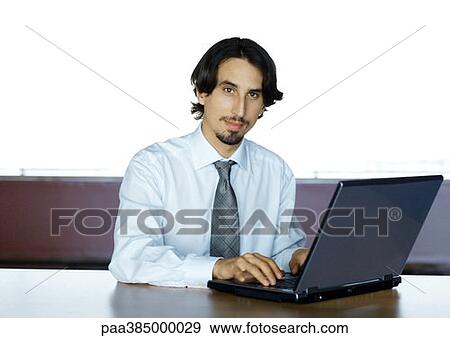 Businessman using laptop, portrait View Large Photo Image Stock Photo - Businessman using laptop, portrait. Fotosearch