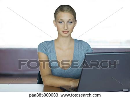 Businesswoman sitting using computer, portrait View Large Photo Image Stock Image - Businesswoman sitting using computer, portrait. Fotosearch