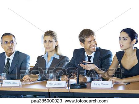 Executives sitting at conference table, one woman speaking View Large Photo Image Stock Image - Executives sitting at conference table, one woman speaking. Fotosearch