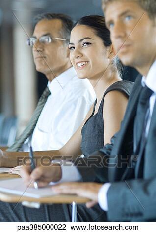 Executives sitting, taking notes View Large Photo Image Stock Image - Executives sitting, taking notes. Fotosearch
