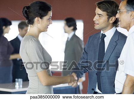 Executives standing, shaking hands View Large Photo Image Stock Photo - Executives standing, shaking hands. Fotosearch