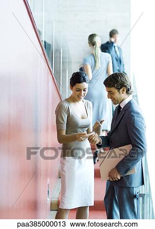 Executives standing, speaking and exchanging business card View Large Photo Image Stock Image - Executives standing, speaking and exchanging business card. Fotosearch
