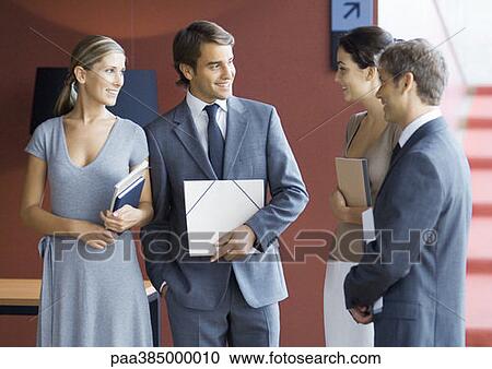 Executives standing, speaking View Large Photo Image Stock Image - Executives standing, speaking. Fotosearch