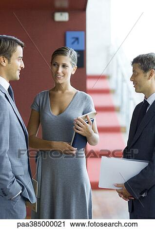 Executives standing, speaking View Large Photo Image Stock Image - Executives standing, speaking. Fotosearch