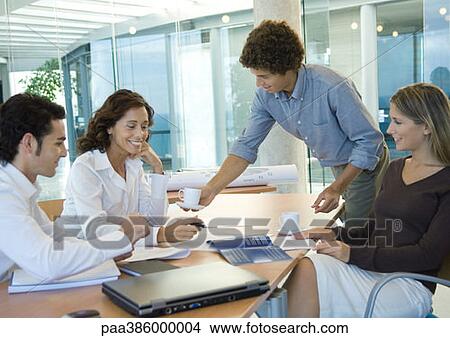 Business associates talking in conference room View Large Photo Image Picture - Business associates talking in conference room. Fotosearch