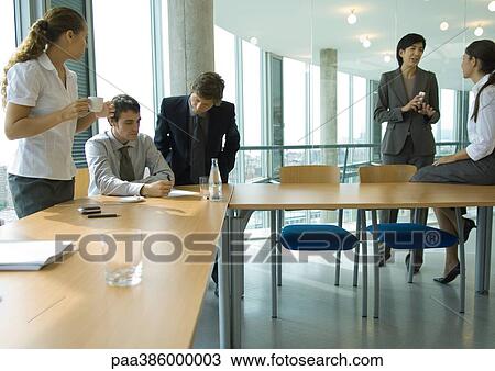 Business associates talking in conference room View Large Photo Image Stock Image - Business associates talking in conference room. Fotosearch