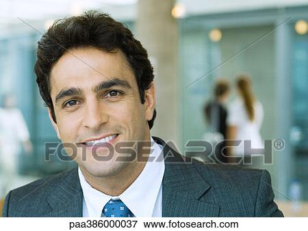 Businessman smiling at camera View Large Photo Image Stock Photo - Businessman smiling at camera. Fotosearch