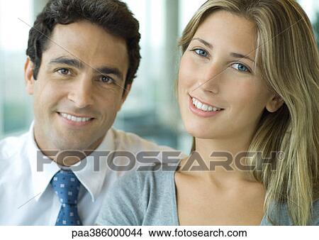 Male and female office workers smiling at camera View Large Photo Image Picture - Male and female office workers smiling at camera. Fotosearch