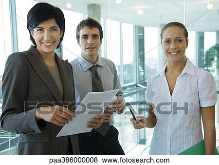 Three business colleagues, smiling at camera View Large Photo Image Stock Photo - Three business colleagues, smiling at camera. Fotosearch