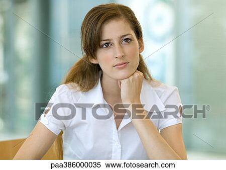 Stock Photography - Young woman, resting head on hand, portrait. Fotosearch