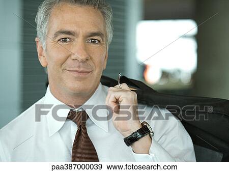 Businessman holding garment bag over back View Large Photo Image Stock Photo - Businessman holding garment bag over back. Fotosearch