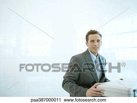 Businessman opening briefcase View Large Photo Image Stock Image - Businessman opening briefcase. Fotosearch