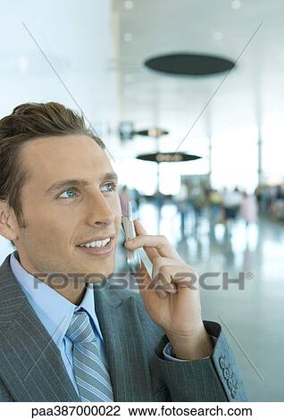 Stock Image - Man using cell phone. Fotosearch